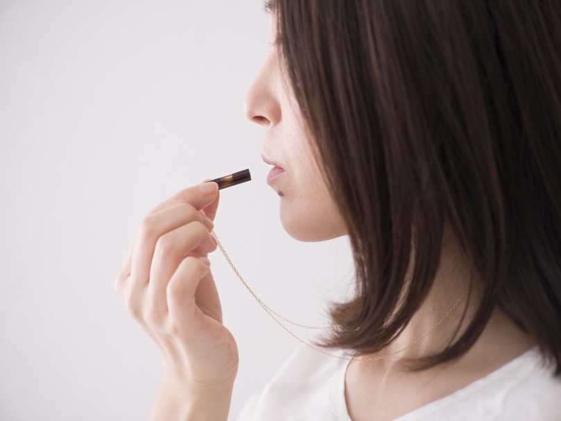 ネックレスにもなる防災笛を吹く女性