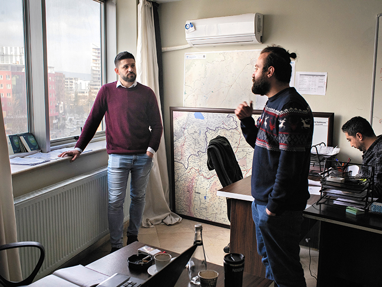 Muhannad Ghabbash, left, with his colleagues at an organization for refugees, in Gaziantep, Turkey, Jan. 23, 2019. “I was among the lucky," said Ghabbash, who survived 19 months in Syrian detention until a judge was bribed to free him. Hundreds of thousands of Syrians have been locked away in filthy prisons where thousands were tortured to death — and the pace of arrests and executions is accelerating. (Laura Boushnak/The New York Times)