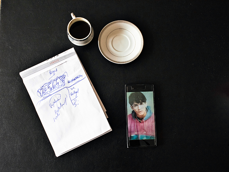 A photo of Riyad Avlar, saved on his phone, showing him at age 18, at his office in Gaziantep, Turkey, Jan. 24, 2019. Avlar was imprisoned in Syria for 20 years after being arrested as a 19-year-old student for interviewing Syrians about a prison massacre. Hundreds of thousands of Syrians have been locked away in filthy prisons where thousands were tortured to death — and the pace of arrests and executions is accelerating. (Laura Boushnak/The New York Times)