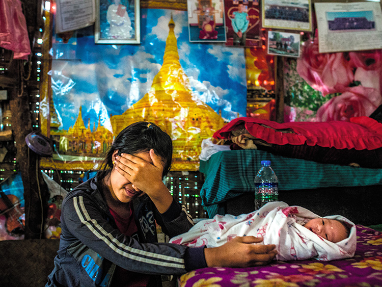 Nyo, 17, an ethnic Wa girl who became a victim of human trafficking, with the baby she was forced to carry, in Mong Yal, Myanmar, March 30, 2019. With women far outnumbered by men in China, some Chinese men are importing wives from neighboring countries, and using force to do so. (Minzayar Oo/The New York Times)